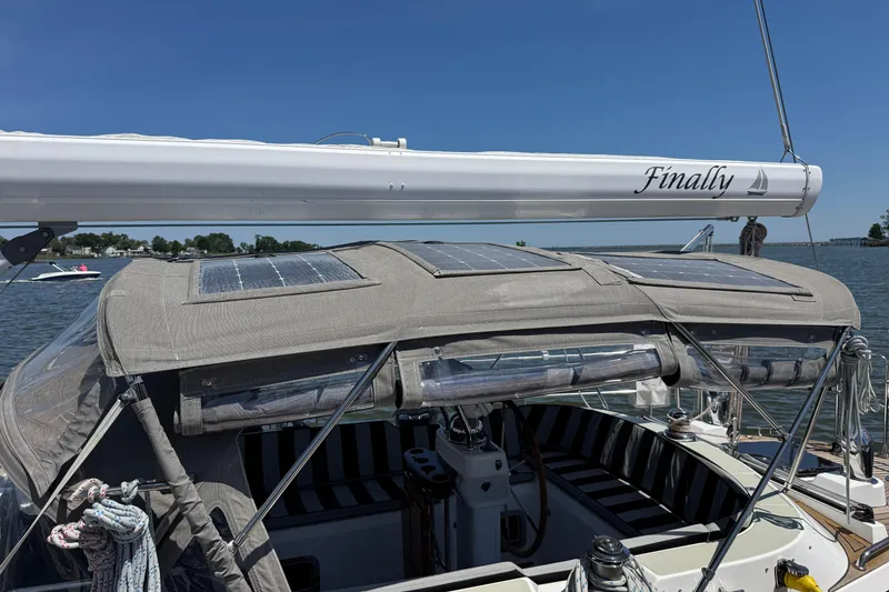 Slide: The Image of Sailboat Hylas H49 (2007) with solar panels on deck, named "Finally," docked on a sunny day. - 64