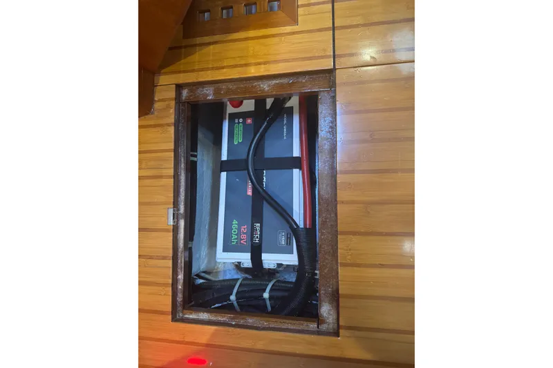 Slide: The Image of Battery compartment of a 2007 Hylas H49 yacht, featuring a 12.8V 460Ah battery. - 50