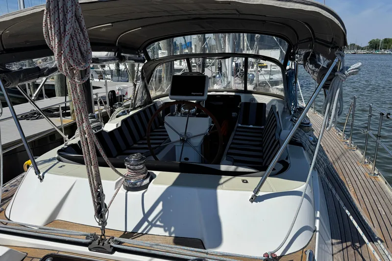 Slide: The Image of 2007 Hylas H49 yacht cockpit with striped seating and navigation equipment at dock. - 70