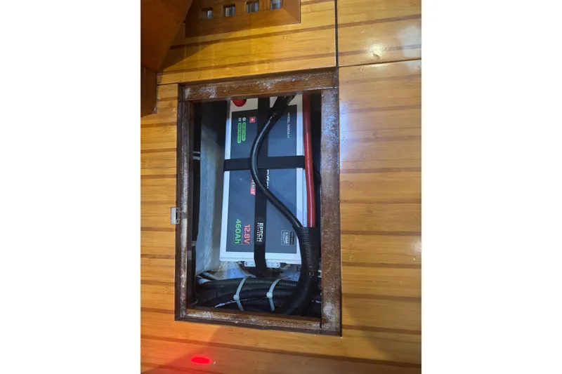 Slide: The Image of Battery compartment of a 2007 Hylas H49 yacht, featuring a 12.8V 460Ah battery. - 51