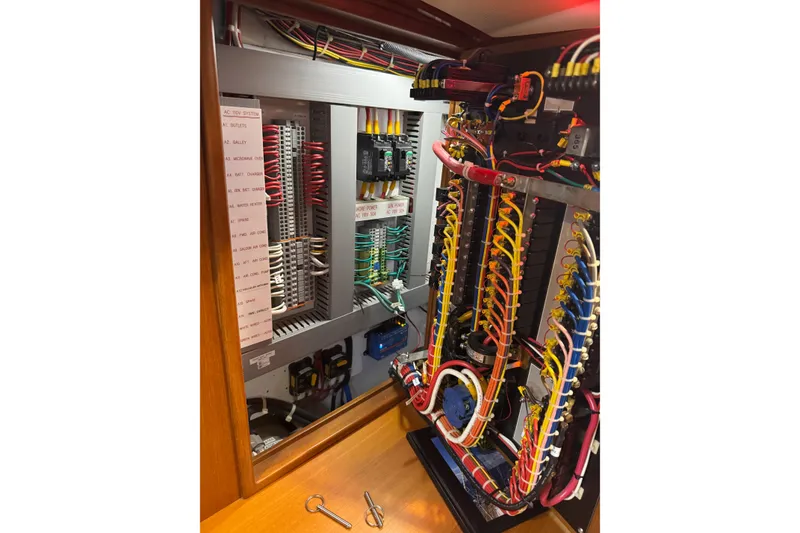 Slide: The Image of Electrical panel with organized wiring inside a 2007 Hylas H49 yacht. - 25