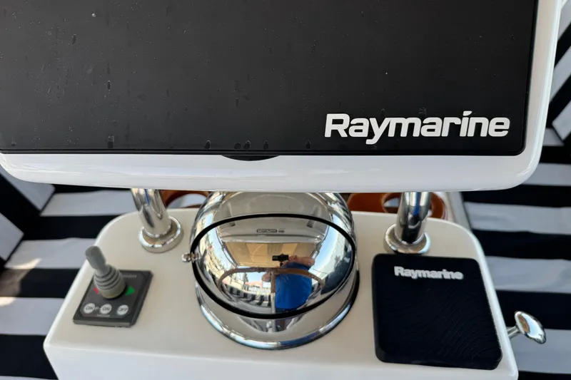 Slide: The Image of Raymarine navigation equipment on a 2007 Hylas H49 yacht, featuring a joystick and compass. - 73