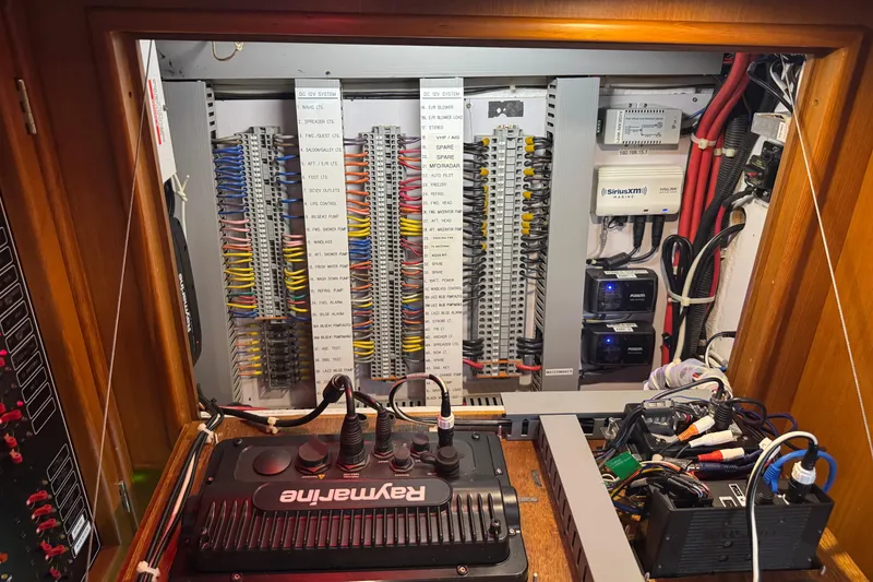 Slide: The Image of Electrical panel of a 2007 Hylas H49 yacht, featuring organized wiring and Raymarine equipment. - 26