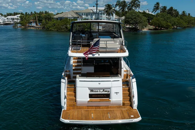 Slide: The Image of Luxury 2020 Princess F70 yacht on serene water, rear view with American flag. - 12