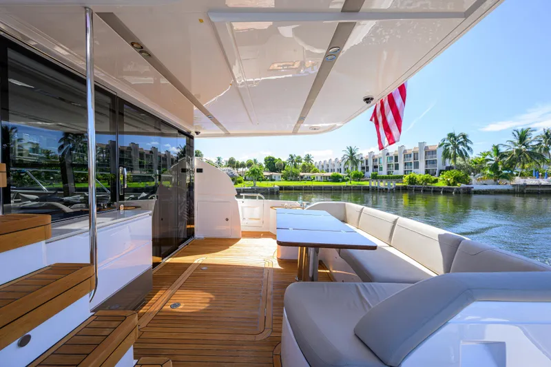 Slide: The Image of Luxurious 2020 Princess F70 yacht deck with seating, table, and waterfront view. - 4