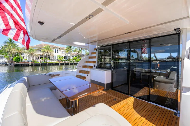 Slide: The Image of Luxurious 2020 Princess F70 yacht deck with seating, table, and waterfront view. - 61