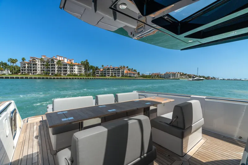 Slide: The Image of Luxurious 2022 Fjord 44 Open yacht with spacious seating, cruising near waterfront properties. - 18