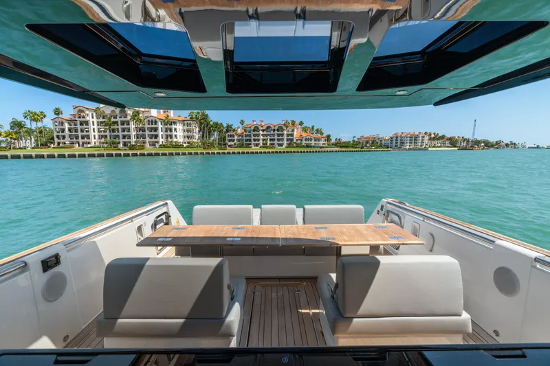 Slide: The Image of 2022 Fjord 44 Open yacht with luxurious seating, overlooking waterfront buildings and clear blue water. - 19