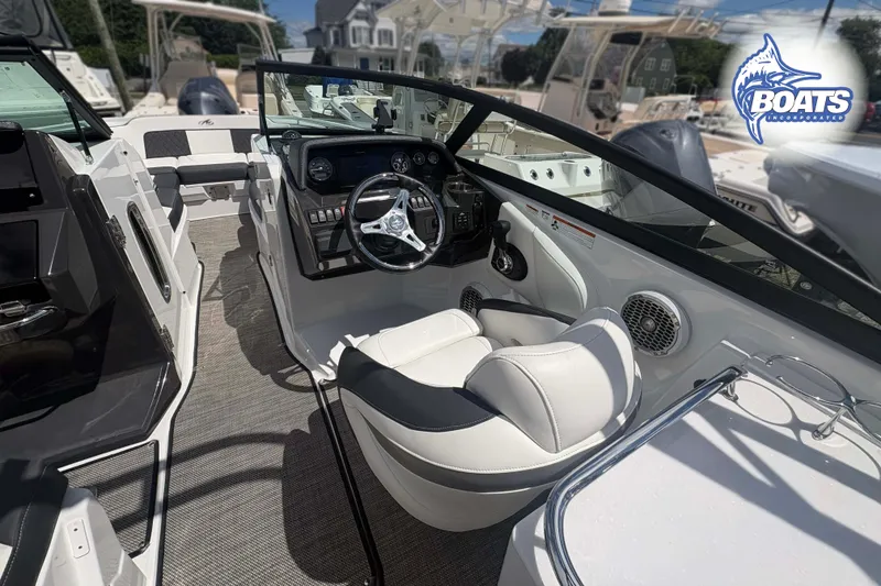 Slide: The Image of Interior of a 2020 Monterey M-65 boat with steering wheel and seating. - 7