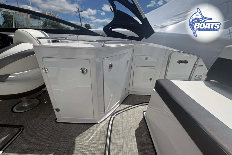 Slide: The Image of 2020 Monterey M-65 boat interior with sleek white cabinetry and seating. - 17