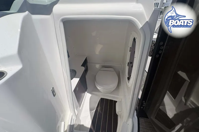 Slide: The Image of 2020 Monterey M-65 boat bathroom interior with toilet and compact design. - 9