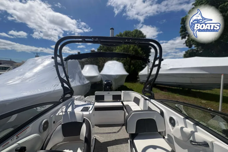 Slide: The Image of 2020 Monterey M-65 boat interior with seating, under a sunny sky at a marina. - 14