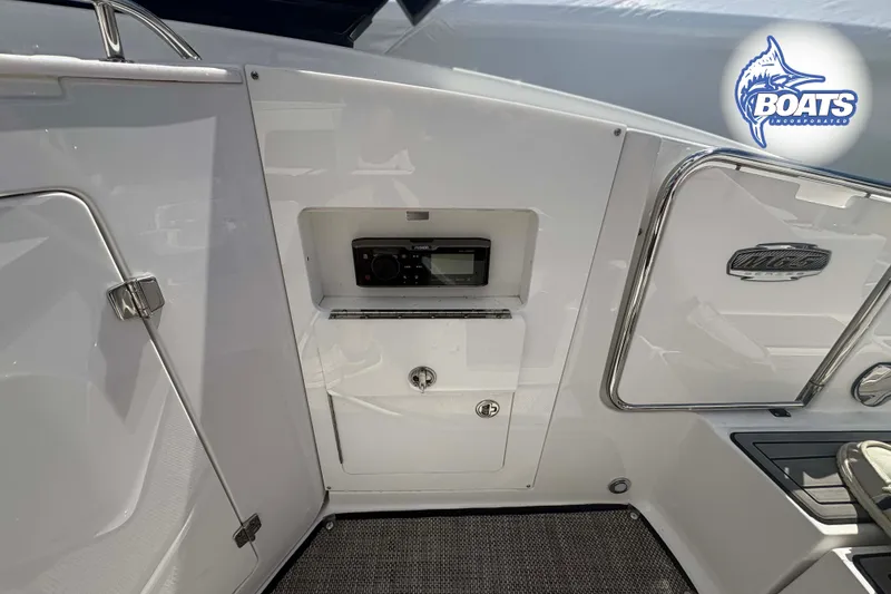 Slide: The Image of Interior view of a 2020 Monterey M-65 boat featuring a control panel and storage compartment. - 15