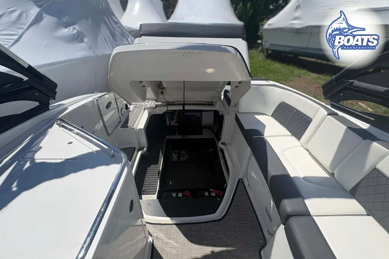 Slide: The Image of 2020 Monterey M-65 boat interior with open engine compartment and seating area. - 11