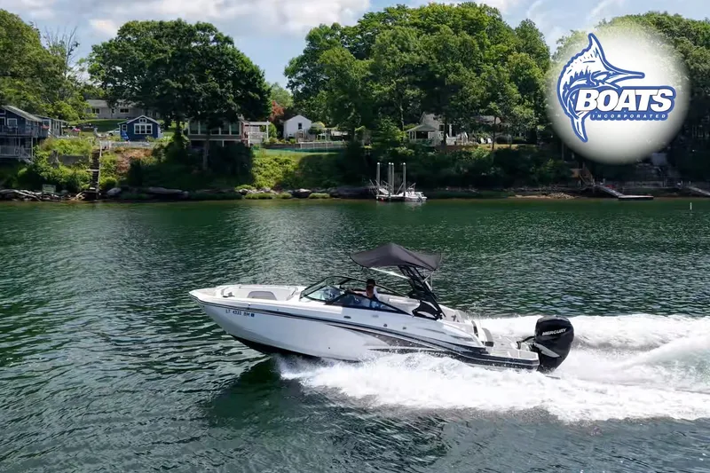 The Image of 2020 Monterey M-65 boat cruising on a scenic lake with lush green shoreline. - 0