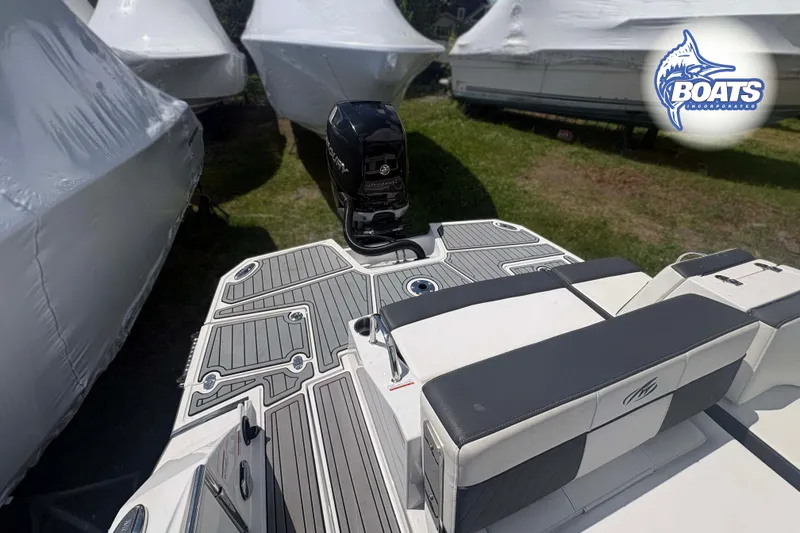 Slide: The Image of Monterey M-65 boat, 2020 model, with sleek deck design and outboard motor, parked outdoors. - 16