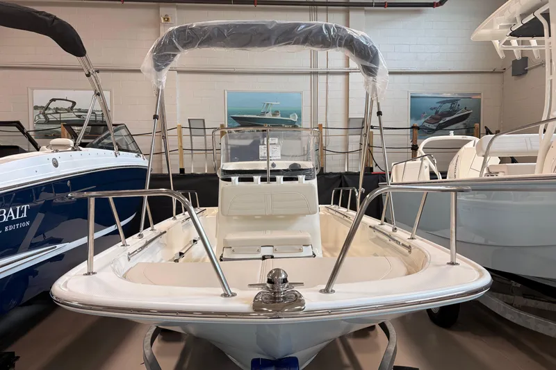 Slide: The Image of 2026 Boston Whaler 150 Montauk boat displayed in a showroom setting. - 2