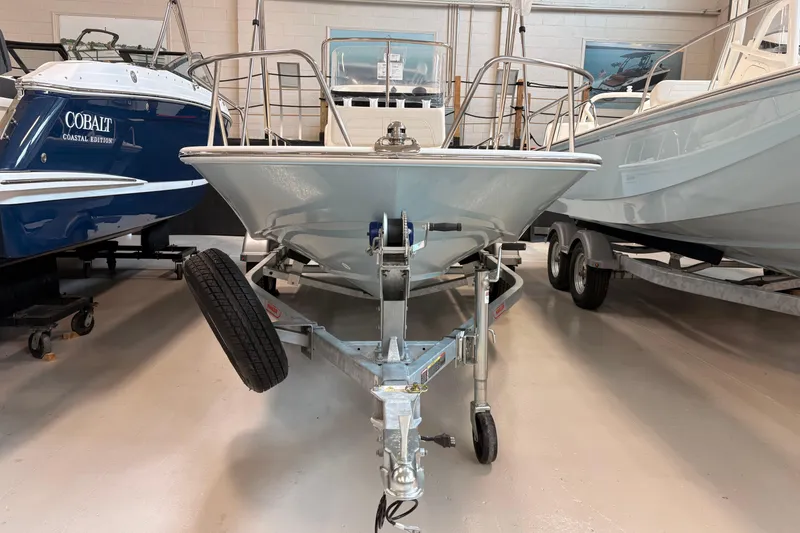 Slide: The Image of 2026 Boston Whaler 150 Montauk boat on trailer in showroom. - 3