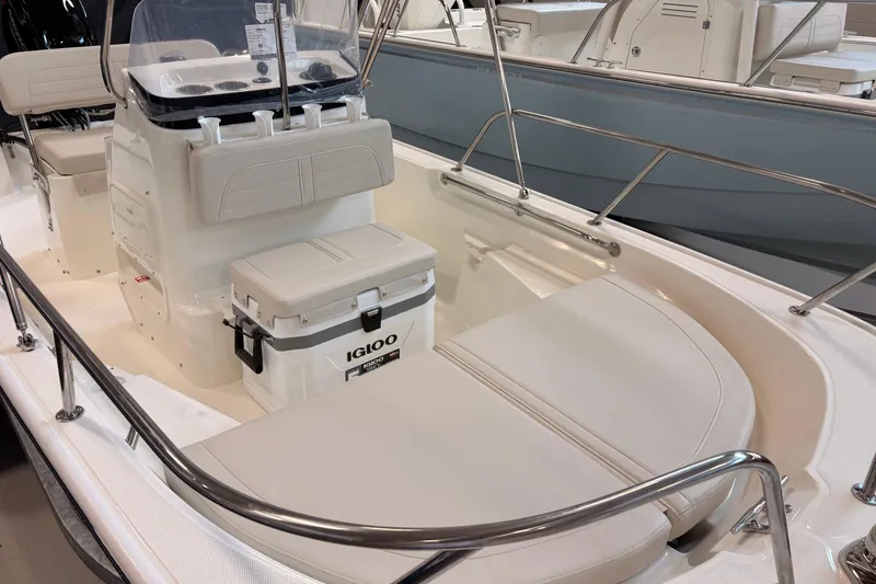 Slide: The Image of 2026 Boston Whaler 150 Montauk interior with seating and Igloo cooler. - 6