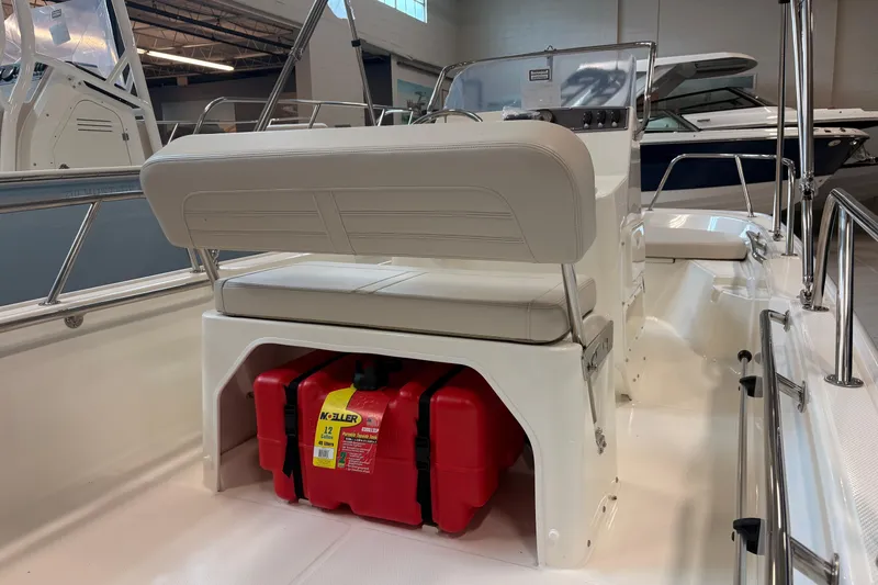 Slide: The Image of 2026 Boston Whaler 150 Montauk interior with seating and storage compartment. - 8