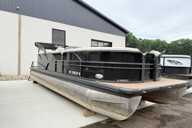 Slide: The Image of 2019 Misty Harbor 2285CF pontoon boat parked outside a building. - 0