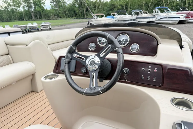 Slide: The Image of 2019 Misty Harbor 2285CF boat dashboard with steering wheel and controls. - 4