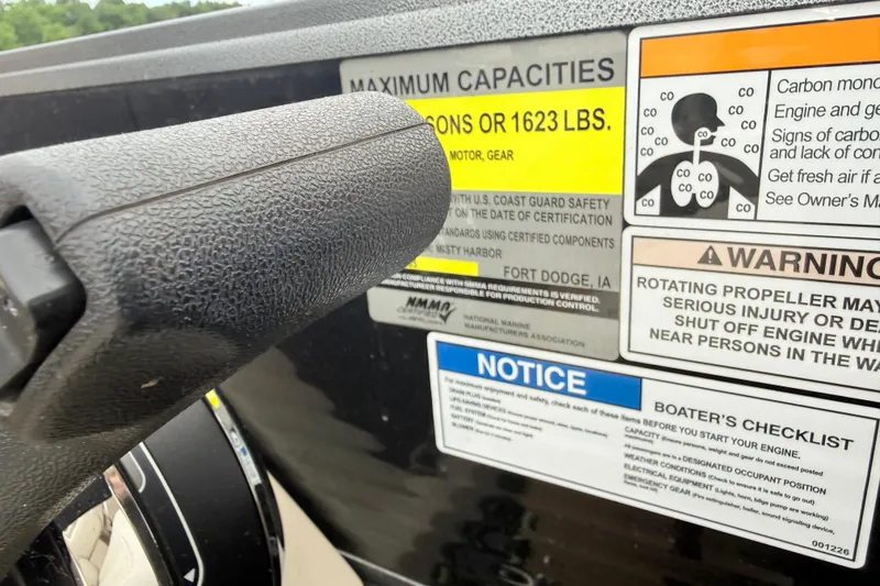 Slide: The Image of Steering wheel and safety labels on a 2019 Misty Harbor 2285CF boat. - 5