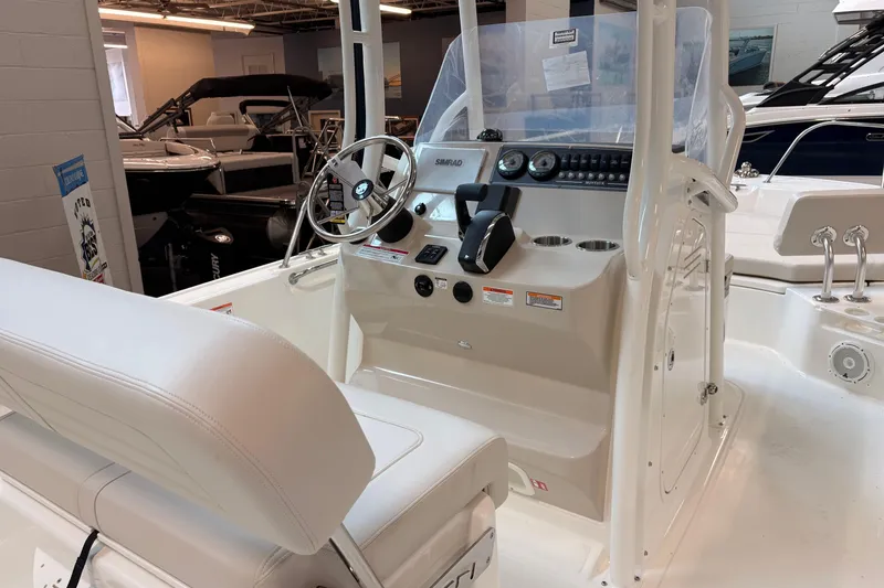 Slide: The Image of 2026 Boston Whaler 210 Montauk boat interior with steering console and seating. - 11
