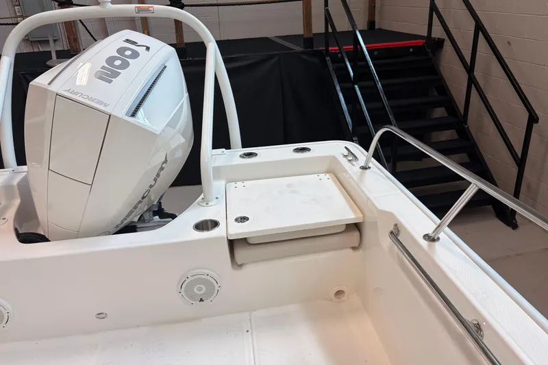 Slide: The Image of 2026 Boston Whaler 210 Montauk boat with Mercury 100 engine, showcasing rear seating and railing. - 13