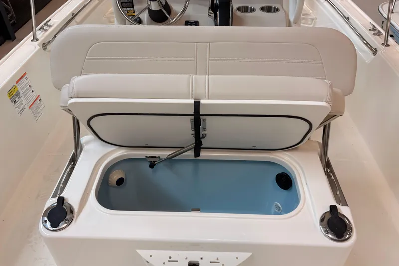 Slide: The Image of 2026 Boston Whaler 210 Montauk boat interior with open storage compartment. - 15