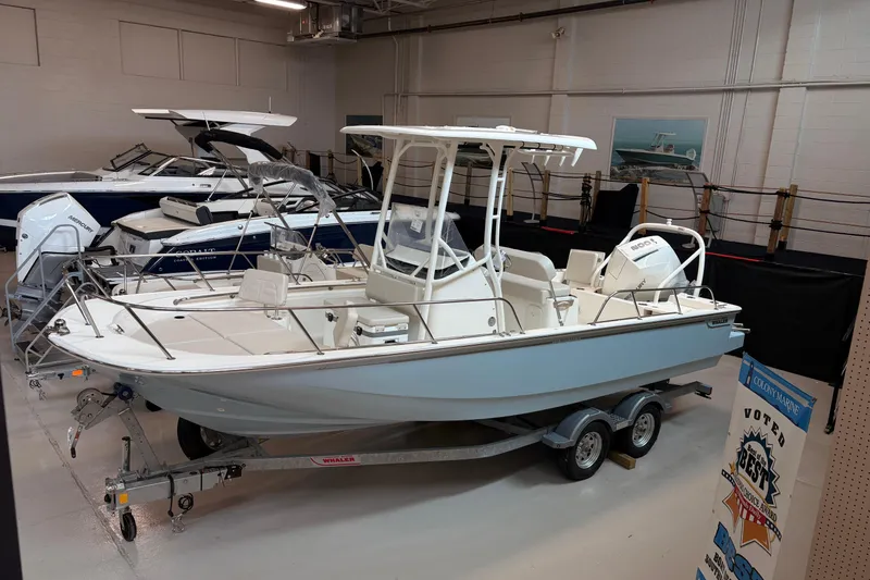 Slide: The Image of 2026 Boston Whaler 210 Montauk boat displayed in showroom on trailer. - 2