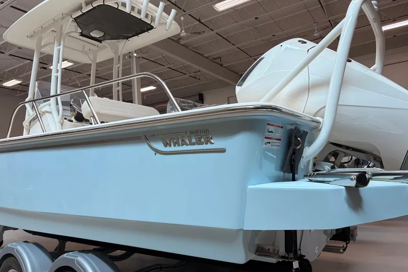 Slide: The Image of 2026 Boston Whaler 210 Montauk boat in showroom, showcasing sleek design and modern features. - 3