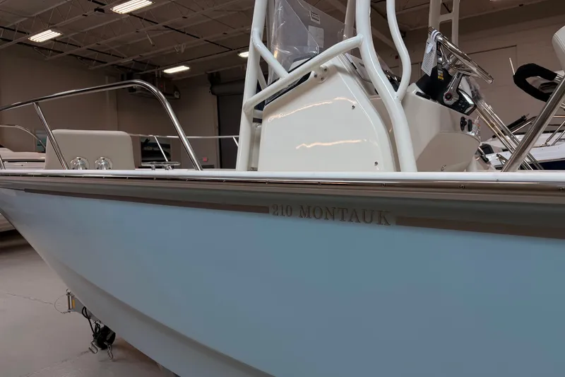 Slide: The Image of 2026 Boston Whaler 210 Montauk boat in showroom, showcasing sleek design and modern features. - 4