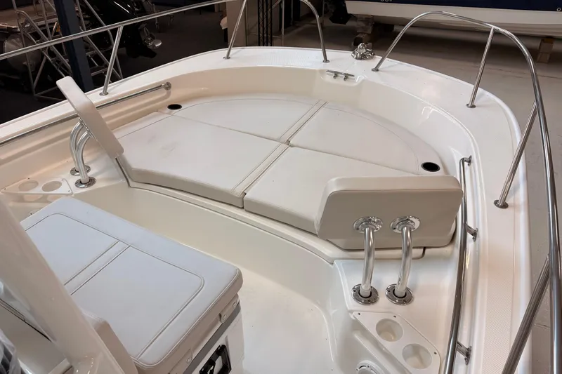 Slide: The Image of 2026 Boston Whaler 210 Montauk boat interior with cushioned seating and stainless steel railings. - 9