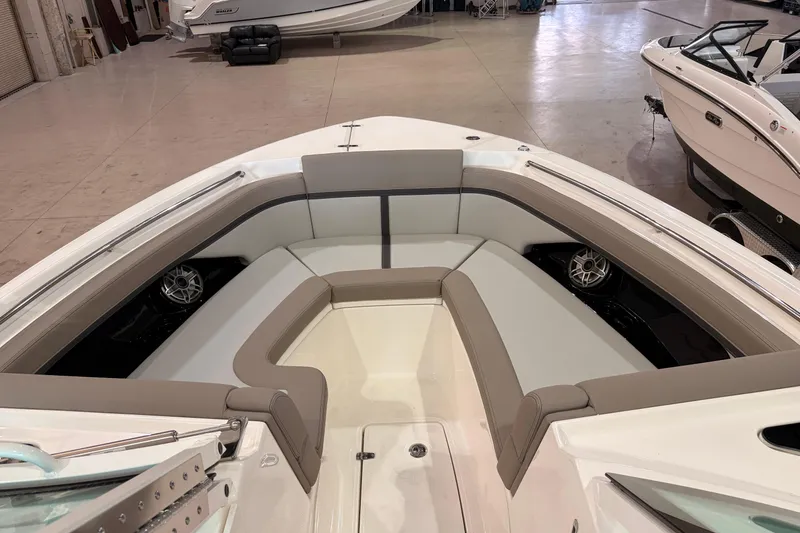 Slide: The Image of 2026 Boston Whaler 330 Vantage boat interior with cushioned seating and speakers. - 14
