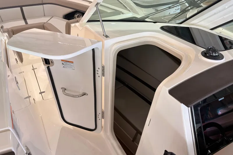 Slide: The Image of 2026 Boston Whaler 330 Vantage cabin entrance with open door, showcasing interior seating. - 15