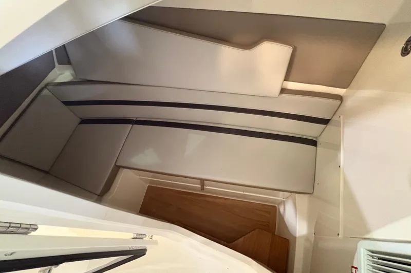 Slide: The Image of Interior cabin of 2026 Boston Whaler 330 Vantage with cushioned seating. - 16
