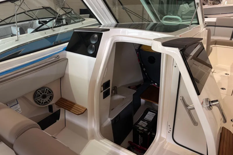 Slide: The Image of 2026 Boston Whaler 330 Vantage interior cabin with seating and storage features. - 17