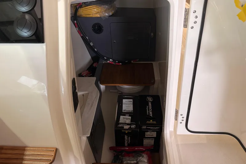 Slide: The Image of Interior of 2026 Boston Whaler 330 Vantage boat with storage and equipment. - 18