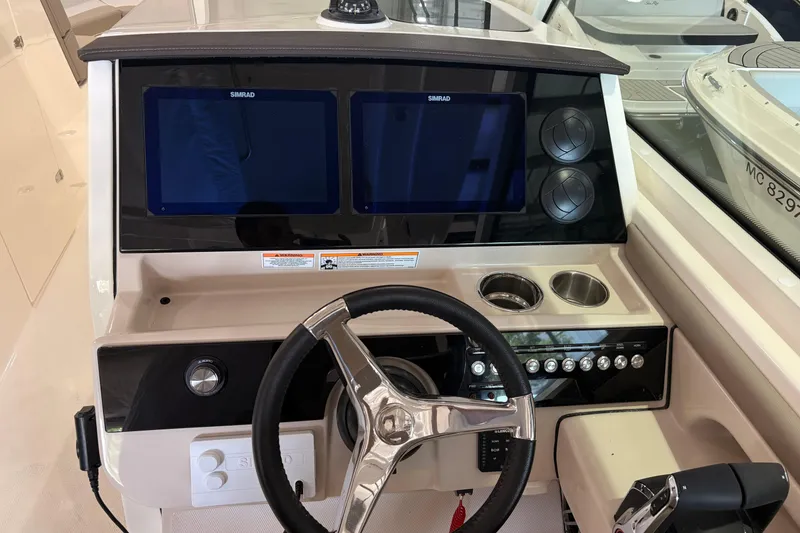 Slide: The Image of Helm of 2026 Boston Whaler 330 Vantage with dual Simrad displays and modern controls. - 19
