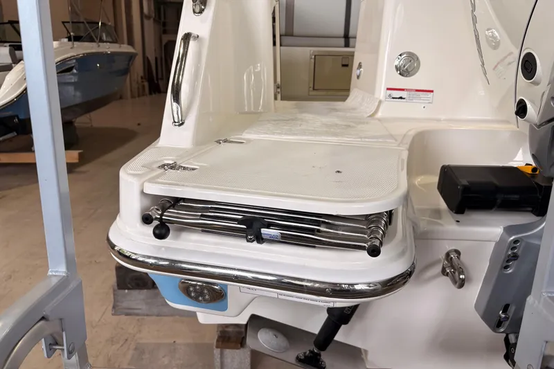 Slide: The Image of 2026 Boston Whaler 330 Vantage swim platform with retractable ladder in a showroom. - 27