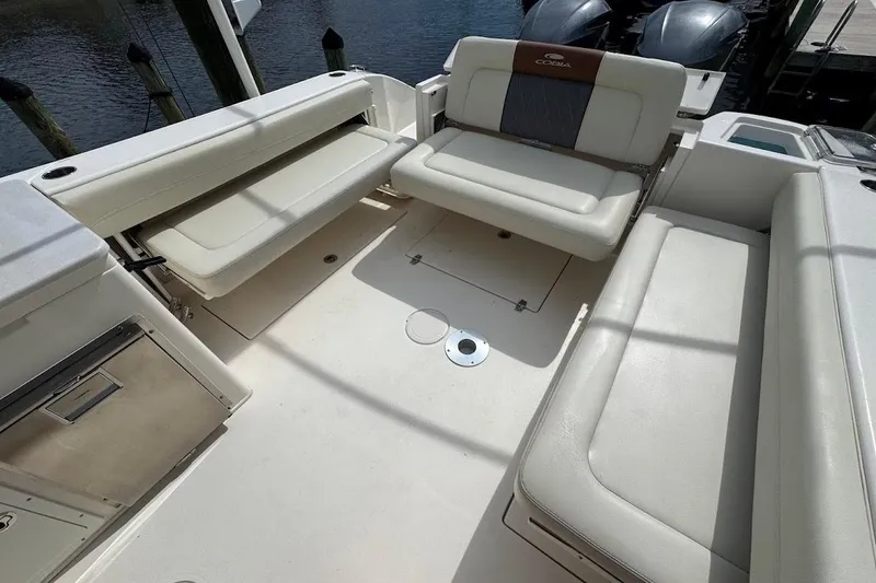 Slide: The Image of 2020 Cobia 280 Dual Console boat interior with cushioned seating and storage compartments. - 36