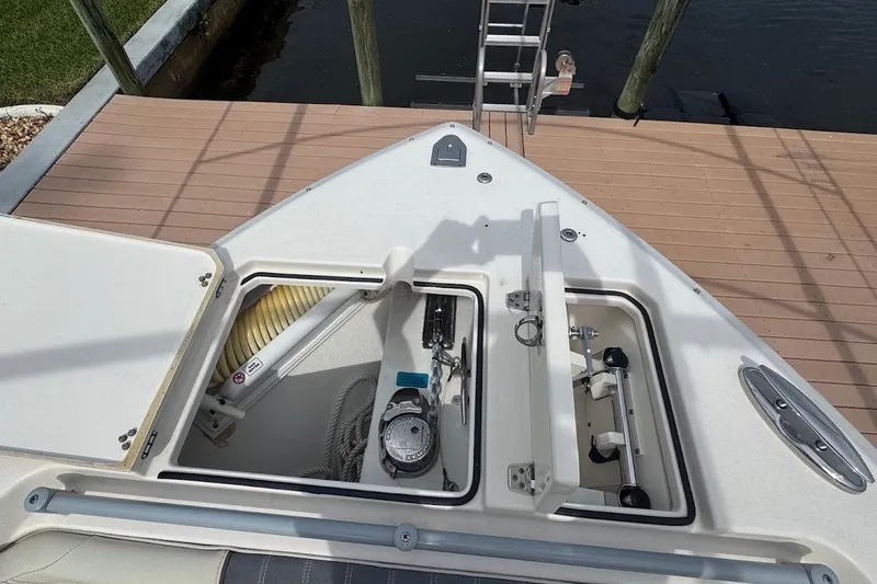 Slide: The Image of 2020 Cobia 280 Dual Console boat storage compartments at dockside. - 14