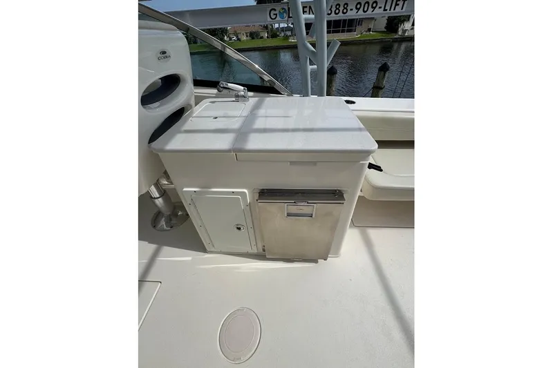 Slide: The Image of 2020 Cobia 280 Dual Console boat interior with sink and storage area. - 26