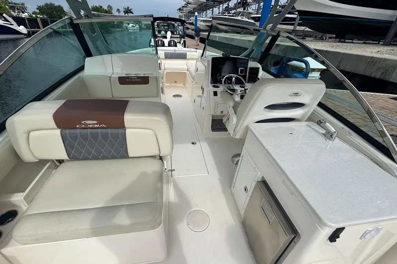 Slide: The Image of 2020 Cobia 280 Dual Console boat interior with seating and helm station. - 11