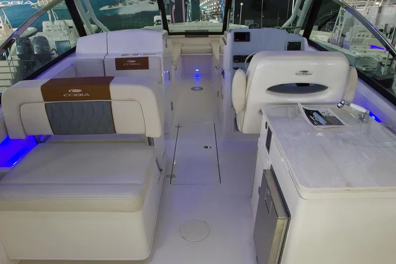 Slide: The Image of Manufacturer Provided Image: Interior of a 2020 Cobia 280 Dual Console boat with seating and amenities. - 12
