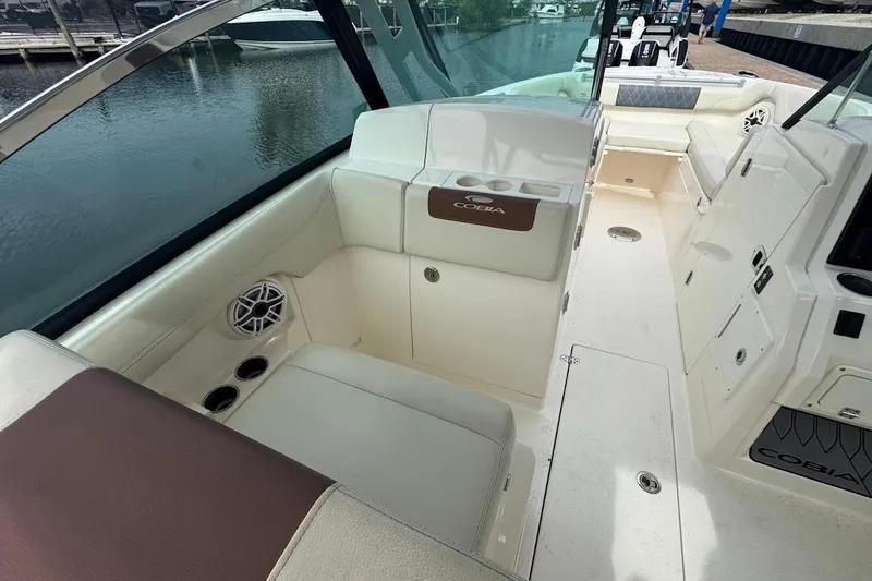 Slide: The Image of 2020 Cobia 280 Dual Console boat interior with seating and cup holders. - 18