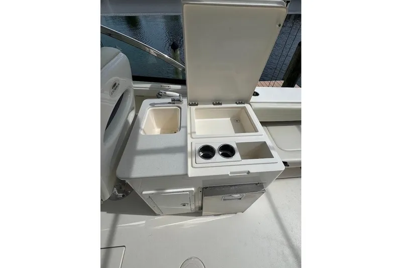 Slide: The Image of 2020 Cobia 280 Dual Console boat interior with sink and storage compartments. - 27
