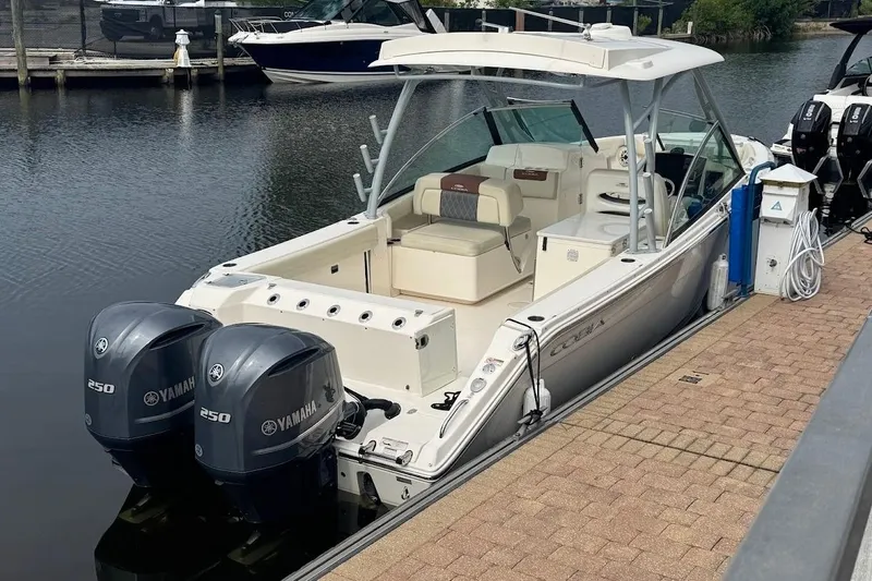 Slide: The Image of 2020 Cobia 280 Dual Console boat docked with twin Yamaha 250 engines. - 26