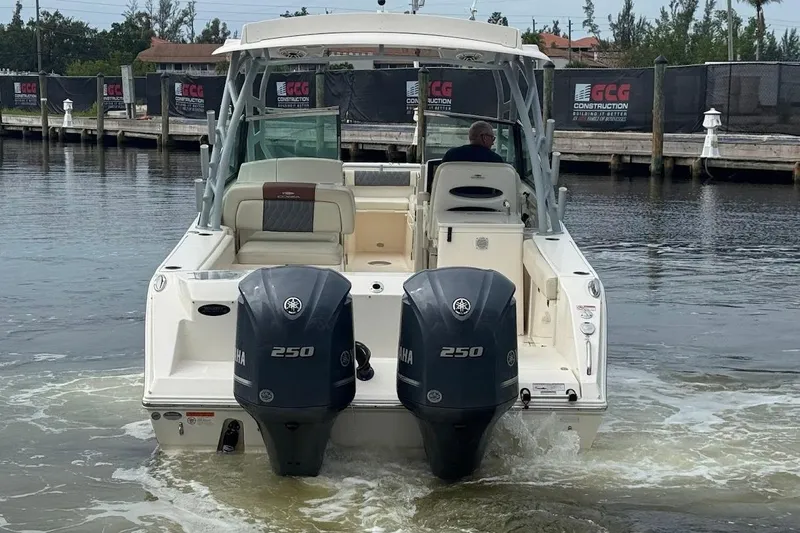 Slide: The Image of 2020 Cobia 280 Dual Console boat with twin Yamaha 250 engines on water. - 28